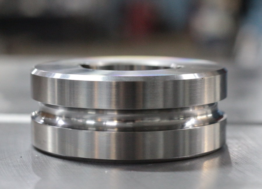 Finished machined roller component with a precision surface